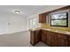 Kitchen space featuring wood countertops and cabinetry, bright lighting, and an open layout at 5627 57Th N Ave, St Petersburg, FL 33709