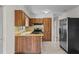 A kitchen features wood cabinets, laminate countertops, stainless steel appliances, and natural light at 5627 57Th N Ave, St Petersburg, FL 33709