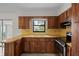 Classic kitchen featuring wood cabinets, tile backsplash, and modern appliances at 5627 57Th N Ave, St Petersburg, FL 33709