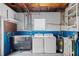 Laundry room featuring a washer, dryer, utility sink, shelving, and blue and white walls at 5627 57Th N Ave, St Petersburg, FL 33709