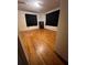 Bedroom featuring hardwood floors, closet, and natural light, creating a serene and comfortable space at 5631 23Rd S Ave, Gulfport, FL 33707