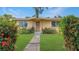 Charming single-story home with a well-maintained front yard and vibrant flowering bushes at 5631 23Rd S Ave, Gulfport, FL 33707