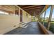A large screened-in porch with a ceiling fan, concrete floor and wooden beams at 5631 23Rd S Ave, Gulfport, FL 33707