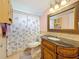 Bathroom featuring decorative mirror, detailed vanity, and shower with curtain at 5870 38Th N Ave # 44, St Petersburg, FL 33710