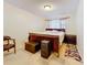Well-lit bedroom with hardwood floors, comfy rug and an elegant dresser at 5870 38Th N Ave # 44, St Petersburg, FL 33710