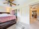Spacious bedroom with a ceiling fan, ensuite, and large platform bed with storage at 5870 38Th N Ave # 44, St Petersburg, FL 33710