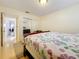 Bedroom featuring floral comforter, wood floors, and mirrored closet at 5870 38Th N Ave # 44, St Petersburg, FL 33710
