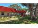Well-maintained condo exterior with lush landscaping, complemented by mature trees at 5870 38Th N Ave # 44, St Petersburg, FL 33710