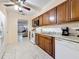 Well-equipped kitchen with wood cabinets, white appliances, and tile flooring at 5870 38Th N Ave # 44, St Petersburg, FL 33710