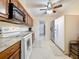 Functional kitchen with white appliances, wood cabinets, and a bright, clean design at 5870 38Th N Ave # 44, St Petersburg, FL 33710