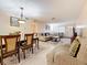 Bright living room and dining area with neutral tones, tile flooring, and comfortable seating at 5870 38Th N Ave # 44, St Petersburg, FL 33710