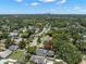 Aerial view of neighborhood showcasing lush trees and a home with a backyard at 6016 N Dexter Ave, Tampa, FL 33604