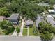 Aerial view of a charming home nestled among lush greenery in a quiet neighborhood at 6016 N Dexter Ave, Tampa, FL 33604
