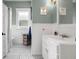 Stylish bathroom with black and white tile floors, beadboard paneling, and updated fixtures at 6016 N Dexter Ave, Tampa, FL 33604