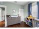 Well-lit bedroom with hardwood floors, a gray dresser, and colorful toys on the shelf at 6016 N Dexter Ave, Tampa, FL 33604