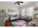 Bright bedroom features hardwood floors, neutral walls, area rug and updated ceiling fan at 6016 N Dexter Ave, Tampa, FL 33604