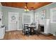Cozy dining room with hardwood floors, a fireplace, and wood ceilings at 6016 N Dexter Ave, Tampa, FL 33604