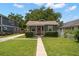 Charming single-story home with a well manicured lawn and inviting front porch at 6016 N Dexter Ave, Tampa, FL 33604