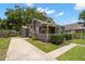Charming single-story home with a gray exterior, inviting front porch and well manicured lawn at 6016 N Dexter Ave, Tampa, FL 33604