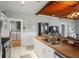 Open kitchen featuring stainless steel appliances, granite countertops, and a view of the laundry area at 6016 N Dexter Ave, Tampa, FL 33604