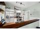 Well-lit kitchen with stainless steel appliances, white cabinets, and a convenient breakfast bar at 6016 N Dexter Ave, Tampa, FL 33604