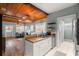 Spacious kitchen with stainless steel appliances, white cabinetry, and seamless flow to dining area at 6016 N Dexter Ave, Tampa, FL 33604