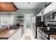 Modern kitchen with stainless steel appliances, white cabinetry, and access to laundry room at 6016 N Dexter Ave, Tampa, FL 33604