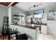 Bright kitchen with white cabinets, stainless steel appliances, and a wooden bar counter at 6016 N Dexter Ave, Tampa, FL 33604