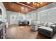 Open-concept living room featuring hardwood floors, wood ceilings and a fireplace at 6016 N Dexter Ave, Tampa, FL 33604