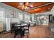 Open-concept living room featuring hardwood floors, wood ceilings, a fireplace and modern finishes at 6016 N Dexter Ave, Tampa, FL 33604
