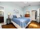 Cozy main bedroom with hardwood floors, blue accents, ensuite bathroom, and walk-in closet at 6016 N Dexter Ave, Tampa, FL 33604