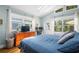 Bright bedroom featuring hardwood floors, vaulted ceilings, a skylight, and a view of the backyard at 6016 N Dexter Ave, Tampa, FL 33604