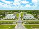 Aerial view showcasing new construction, surrounding landscaping, and community layout with common areas and resident parking at 6210 64Th N Way, Pinellas Park, FL 33781