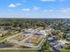 Aerial view of newly constructed homes in a community surrounded by trees and a pond at 6210 64Th N Way, Pinellas Park, FL 33781