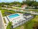 Aerial view of the community pool with ample seating, cabana, and lush landscaping, perfect for recreation and relaxation at 6210 64Th N Way, Pinellas Park, FL 33781