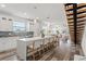Modern, all-white kitchen with a large island, quartz countertops, and stainless steel appliances open to the living area at 6210 64Th N Way, Pinellas Park, FL 33781