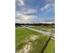 Vacant land with a newly paved road and a partially cloudy sky above at 6210 64Th N Way, Pinellas Park, FL 33781