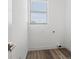Clean and functional laundry room with light vinyl flooring, a window for natural light, and utility connections at 6210 64Th N Way, Pinellas Park, FL 33781
