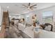 Bright, open-concept living room with wood floors, modern staircase, and an eat-in kitchen at 6210 64Th N Way, Pinellas Park, FL 33781