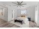 Bright main bedroom with a ceiling fan, luxury carpet, accent pillows, and modern furnishings, creating a serene atmosphere at 6210 64Th N Way, Pinellas Park, FL 33781