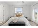 Bright and modern main bedroom, featuring decorative pillows, a ceiling fan, and a cozy rug at 6210 64Th N Way, Pinellas Park, FL 33781