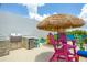 Rooftop deck featuring an outdoor kitchen with stainless steel grill and a cozy seating area under a tiki umbrella at 6210 64Th N Way, Pinellas Park, FL 33781