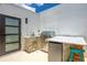 Convenient outdoor kitchen with stainless steel grill, ample counter space, and a mini-fridge for easy entertaining at 6210 64Th N Way, Pinellas Park, FL 33781