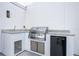 Modern outdoor kitchen with stainless steel grill, ample countertop space, and sleek white cabinetry at 6210 64Th N Way, Pinellas Park, FL 33781