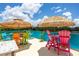 Inviting rooftop deck with colorful seating and tiki umbrellas, perfect for enjoying the weather and the view at 6210 64Th N Way, Pinellas Park, FL 33781
