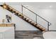 Modern staircase featuring wood treads and a sleek metal railing, set against a clean, minimalist interior at 6210 64Th N Way, Pinellas Park, FL 33781