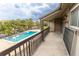 Relaxing balcony view overlooking a sparkling community pool surrounded by lush palm trees and ample seating at 6332 Newtown Cir # 32B2, Tampa, FL 33615