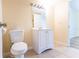 Clean bathroom featuring a toilet and sink with white cabinets at 6332 Newtown Cir # 32B2, Tampa, FL 33615