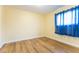 Room featuring wood-look flooring, neutral colored walls, and a window with curtains at 6332 Newtown Cir # 32B2, Tampa, FL 33615