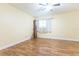 Cozy room featuring wood-look flooring, ceiling fan, and a window with curtains at 6332 Newtown Cir # 32B2, Tampa, FL 33615